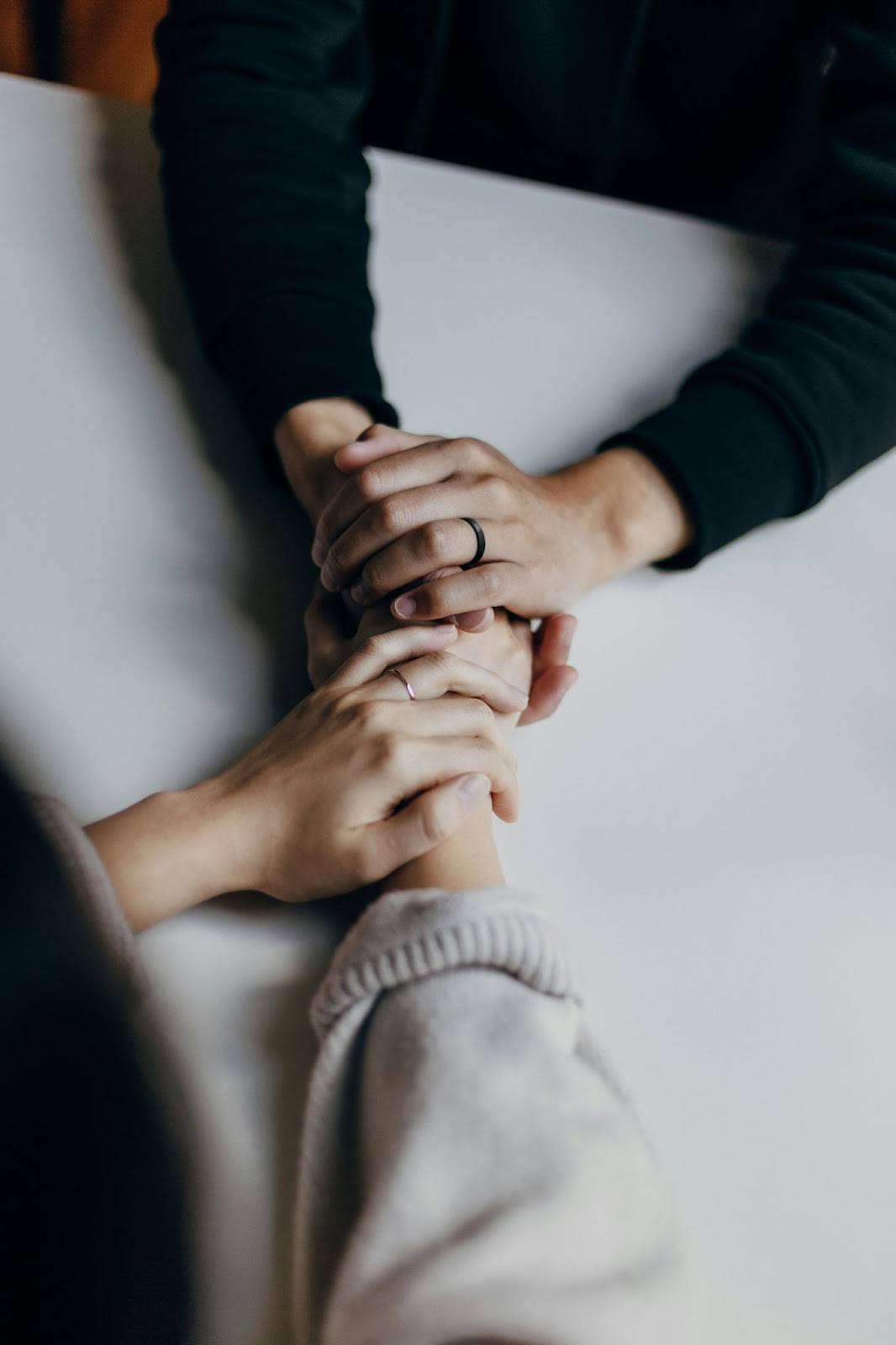 two people showing support for eachother by holding hands 